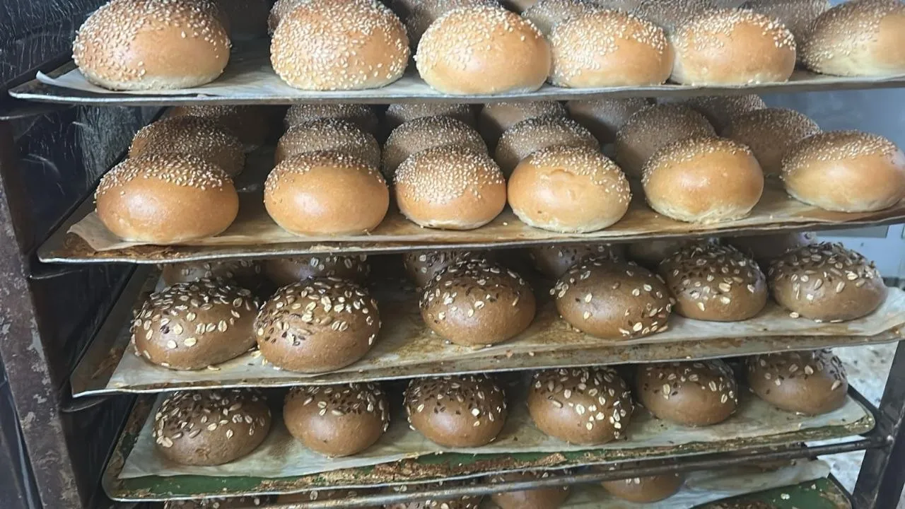 Sesame and oat burger buns on the rack